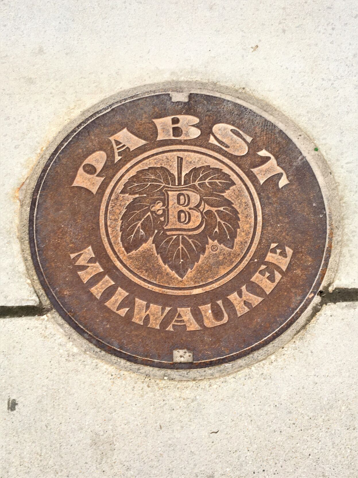 Decorative Pabst logo manhole cover at The Brewery District in downtown Milwaukee